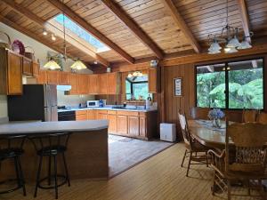 a kitchen with a table and chairs in a room at Hale Mauna Loa Upper Level with shared Hot Tub in Volcano