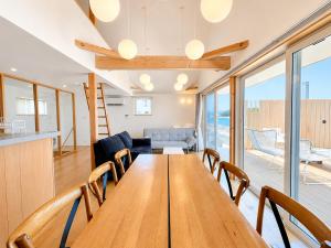 a dining room and kitchen with a wooden table and chairs at Beach SPA TSUDA 0 Cero棟 in Sanuki +62 photos