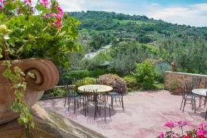 a patio with tables and chairs and flowers at Agriturismo La Casella in San Terenziano