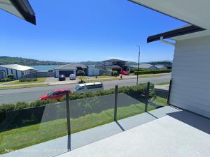 a view of a street from the balcony of a house at Waterview Spacious Bliss - 2 Beds in Porirua