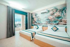 a bedroom with two beds and a mural of flowers at Khách sạn Chinh Thuỷ in Sầm Sơn