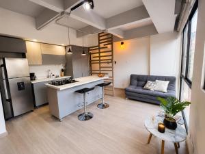 a kitchen and living room with a couch and a table at Lovely Private Apto in Poblado in Medellín +6 photos