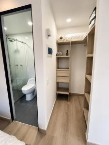 a small bathroom with a toilet and a shower at Lovely Private Apto in Poblado in Medellín