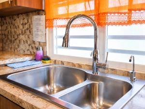 a stainless steel sink in a kitchen with a window at Arenales Guest House in Isabela +22 photos