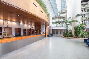 an empty lobby of a building with plants at Meliá Benidorm in Benidorm +40 photos