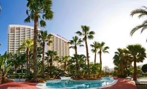 a resort with palm trees and a hotel at Meliá Benidorm in Benidorm