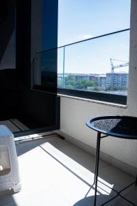 a room with a table and a large window at T&M Apartman Premium 2 in Paraćin