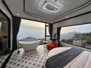 a bedroom with a tub and a bed and a window at Time Villa in Tam Ðảo +39 photos
