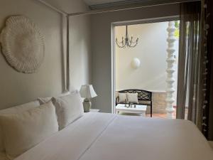 a bedroom with a large white bed and a balcony at O - HO Boutique Home in Ban Tai +100 photos