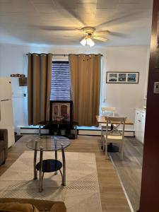 a living room with a table and a dining room at Cozy Home in Flin Flon