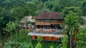 a house in the middle of a forest at Gateway Inn PuLuong in Pu Luong