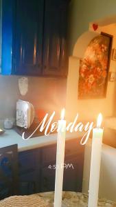 two candles on a kitchen counter with a happy anniversary sign at Keisha's luxury stays in Santa Cruz