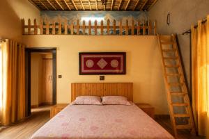 a bedroom with a bunk bed and a ladder at Ramashray - Mud House Living in Haldwāni