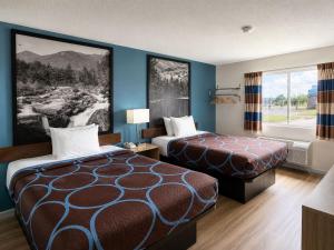 a hotel room with two beds and a window at Super 8 by Wyndham Canandaigua in Canandaigua