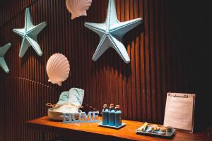 a table with starfish on a wall and a sign that says home at SOL by Meliá Phu Quoc in Phú Quốc