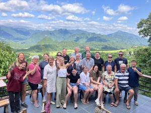 a group of people posing for a picture in the mountains at Gateway Inn PuLuong in Pu Luong +12 photos