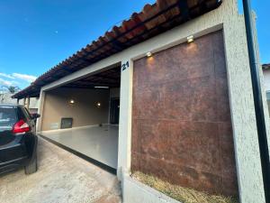 a garage with a car parked in front of it at Conforto - Casa completa com ar-cond - Wi-Fi in Trindade