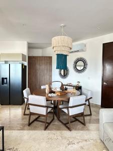 a kitchen and dining room with a table and chairs at Navela oceanfront apartment in Telchac Puerto