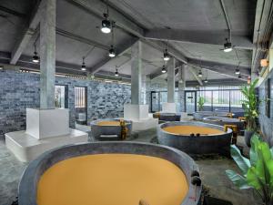 a large room with a bunch of tubs at Kobi Onsen Resort Hue, Affiliated by Meliá in Hue +60 photos