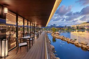 a restaurant with a view of a river at Kobi Onsen Resort Hue, Affiliated by Meliá in Hue