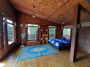 a bedroom with a bed and a rug on the floor at Salak Sunrise Homestead in Bogor
