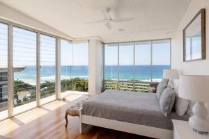 a bedroom with a bed and views of the ocean at The Beach Shack: Getaway on Sunshine Beach in Noosa Heads +30 photos