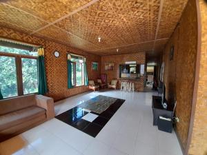 a large living room with a couch and a table at Salak Sunrise Homestead in Bogor