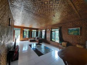 a living room with a couch and a table at Salak Sunrise Homestead in Bogor +14 photos