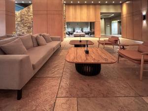 a living room with a couch and tables at Hotel Alejandro I, Affiliated by Meliá in Salta