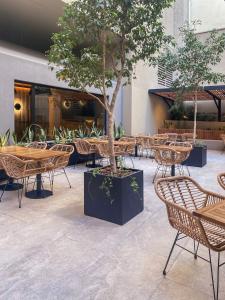 a restaurant with tables and chairs and a tree at Hotel Alejandro I, Affiliated by Meliá in Salta +51 photos