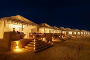 a row of tents in the desert at night at Jaisalmer Sand Dunes Resort in Jaisalmer