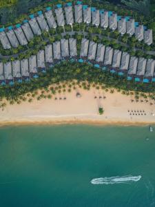 an aerial view of a beach with a boat in the water at Meliá Vinpearl Phu Quoc in Phú Quốc +45 photos