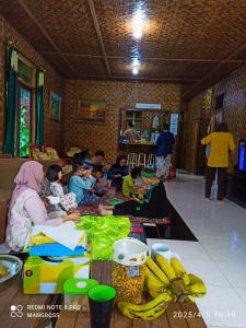 a group of people sitting around a table with bananas at Salak Sunrise Homestead in Bogor