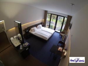 Postel nebo postele na pokoji v ubytování Hotel Victoria