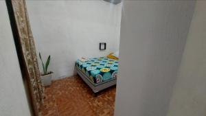 a bedroom with a bed in a room with a mirror at Habitacion Amatitlan in Amatitlán