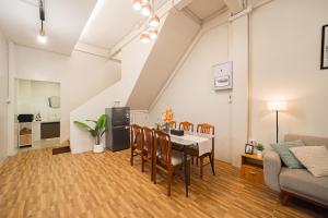 a living room with a table and chairs and a couch at Siam Place - Spacious Family House in Bangkok in Bangkok