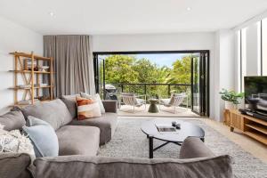 a living room with a couch and a table at Beach Luxury, Ocean Views & Pool in Noosa Heads