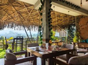 a restaurant with a table and chairs and a view at Ella Dream Mount in Ella