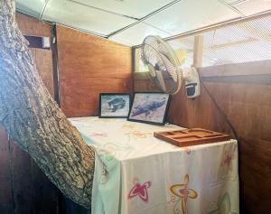 a table in a boat with a fan on it at Green Tree House Yala in Yala