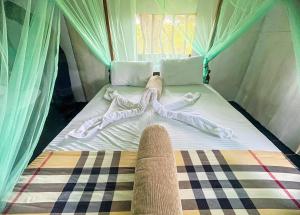 a bed in a tent with four pillows at Green Tree House Yala in Yala