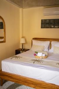 a bed with a basket of flowers on it at Seraya Villas in Kuta Lombok