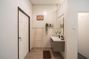 a white bathroom with a sink and a ladder at Siam Place - Spacious Family House in Bangkok in Bangkok +81 photos