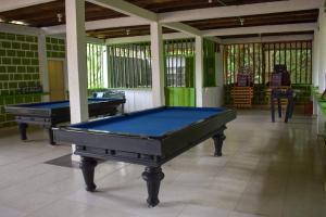 a room with two pool tables in it at hotel con piscina Ladrilleros in Ladrilleros