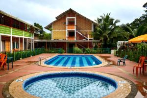 a swimming pool in front of a house at hotel con piscina Ladrilleros in Ladrilleros