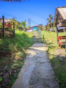 a stone path leading up a hill to a house at hotel con piscina Ladrilleros in Ladrilleros