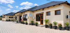a building with potted plants in front of it at NEBCON Executive Lodge in Kitwe