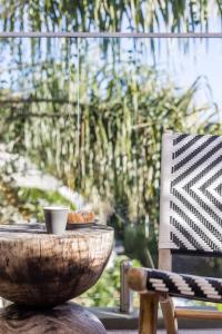 a bowl of food sitting on a table next to a chair at Hastings Park: Lavish Ocean Vista Luxury in Noosa Heads