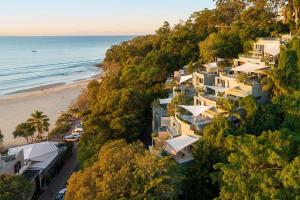 an aerial view of a house on a hill next to the beach at Hastings Park: Lavish Ocean Vista Luxury in Noosa Heads +30 photos
