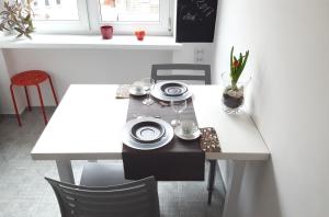 a table with plates and dishes on top of it at Apartament Centrum Rynek in Poznań