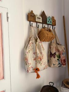 three bags are hanging on a wall at B&B Vernole1713 in Vernole
